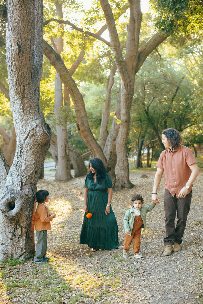 Family of four walking around John Hinkel Park during their East Bay family photos.