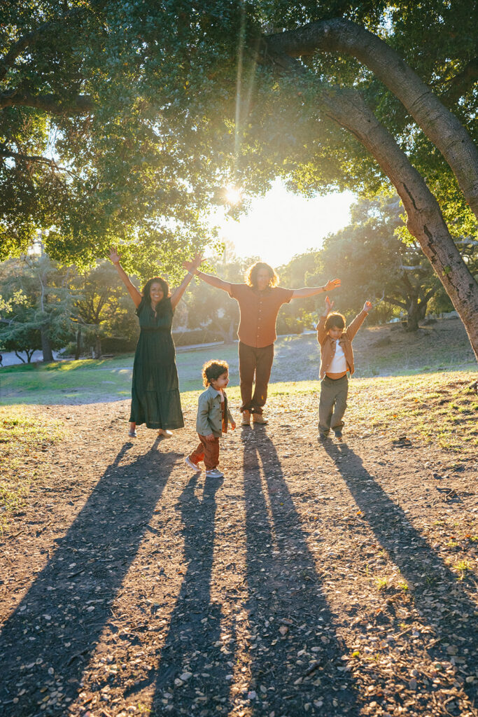 Family jumping up on the air during their fall family photos at John Hinkel Park in the East Bay.