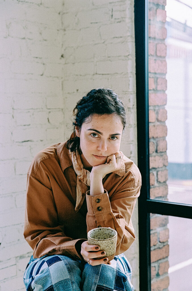 Film photo of a Bay Area therapist holding tea in a light-filled Emeryville studio.