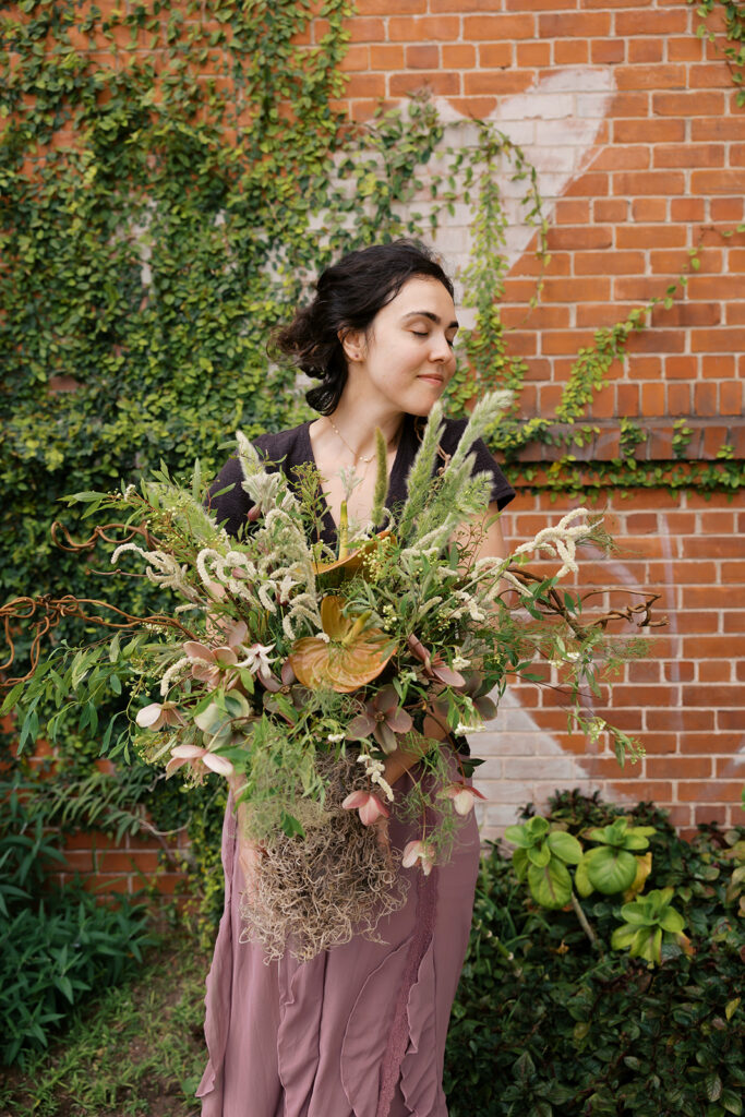 Bay Area therapist holding flowers outside during an editorial branding photoshoot.