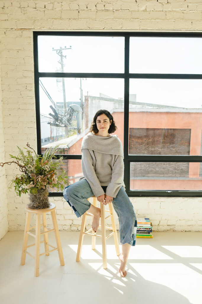 Bay Area therapist sitting in a light-filled Emeryville studio during a branding photoshoot.