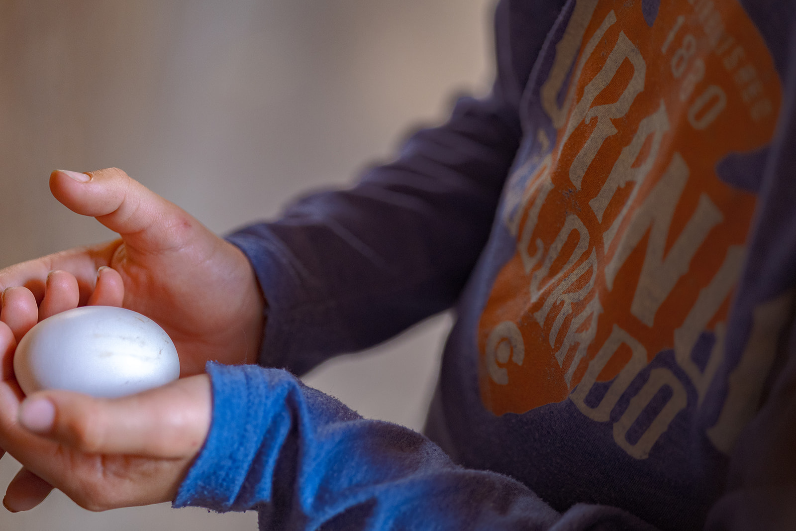 Kid holding egg. 