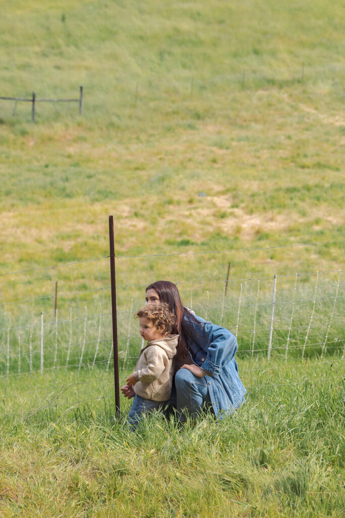 Mother and child watching goat milking at Slide Ranch.