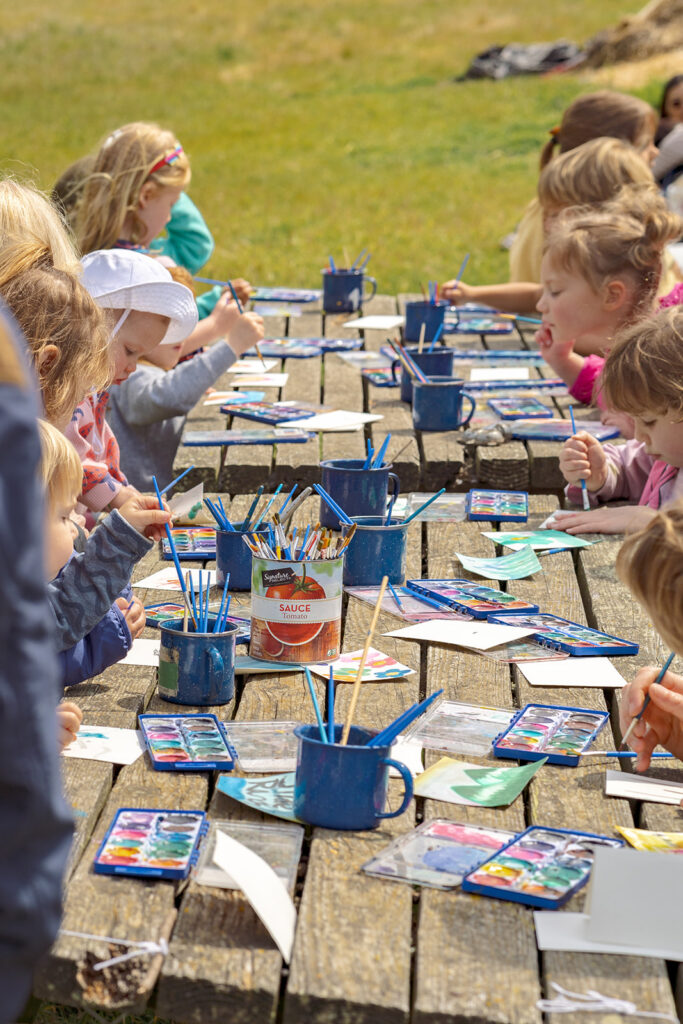 Kids painting during Slide Ranch Spring Fling 2025.