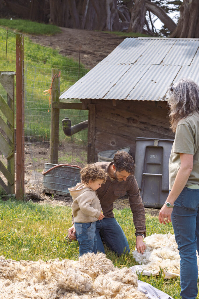 Father and son learning about sheep sheering at Slide Ranch during 2025 Spring Fling.