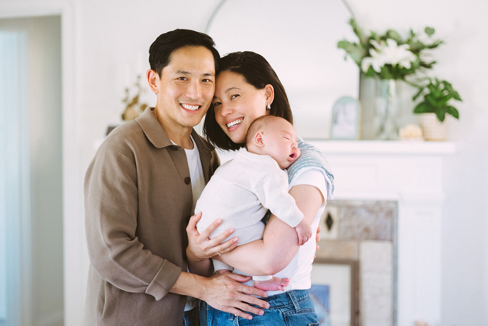 Couple posing with their newborn during their at-home East Bay newborn photography session.