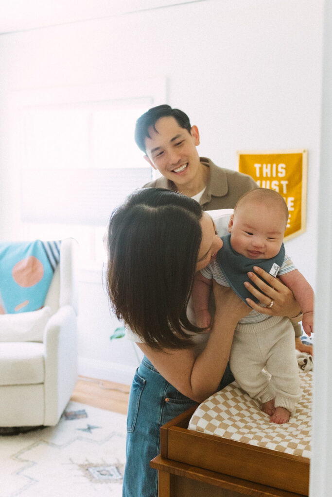 Parents with their newborn son in his nursery.