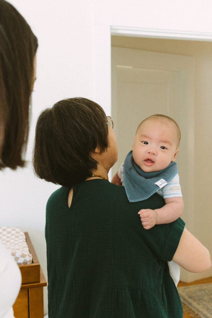 Grandmother holding her newborn grandson.