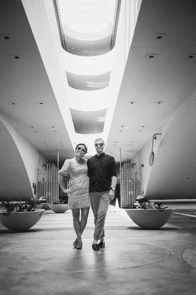 Black and white Bay Area engagement photo of a couple posing inside Marin County Civic Center.