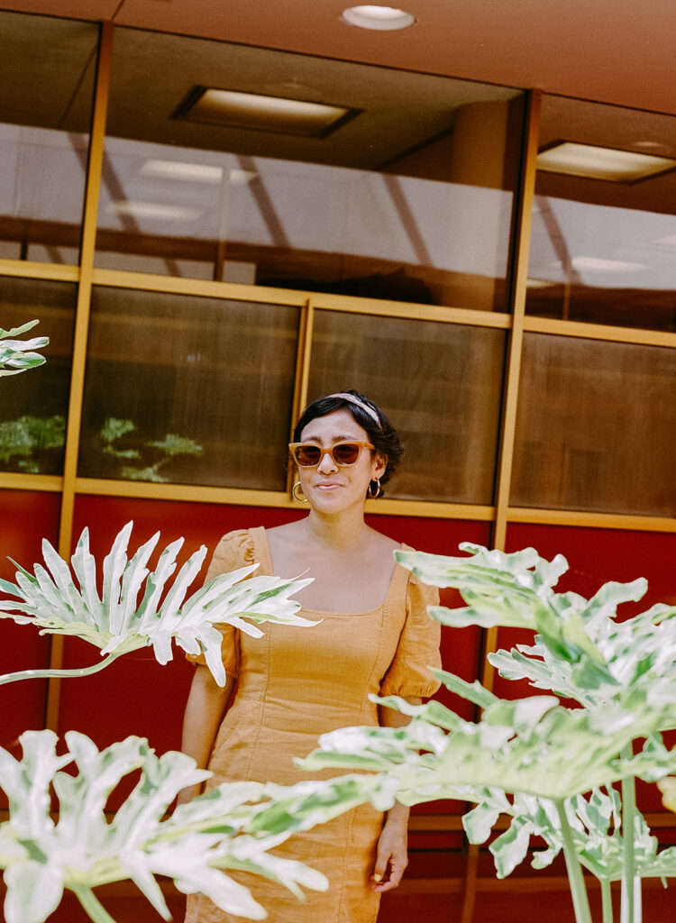 Colorful film portrait of a woman in a yellow dress and sunglasses at Marin County Civic Center.