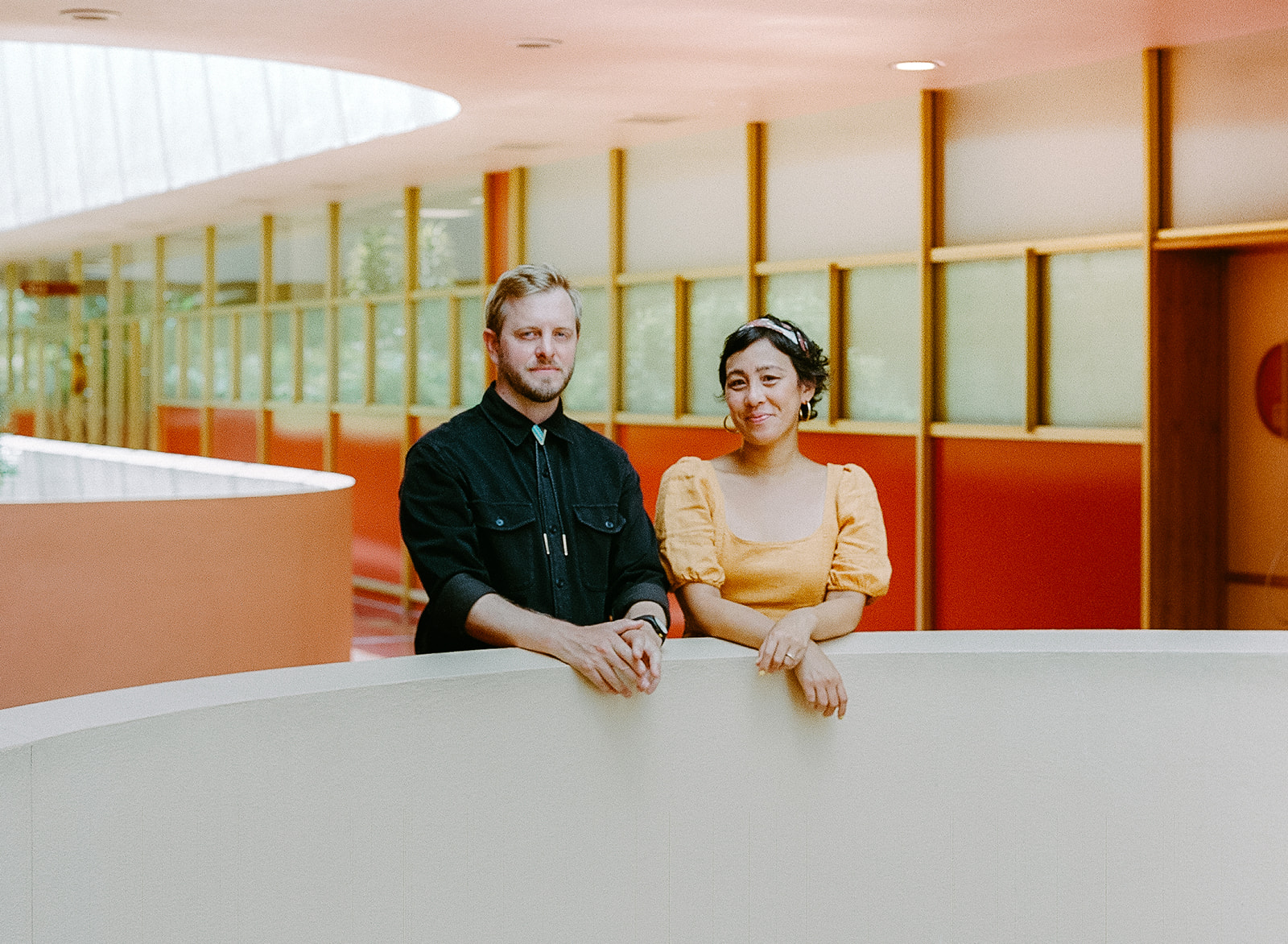 Couple leaning against a wall at Marin County Civic Center.