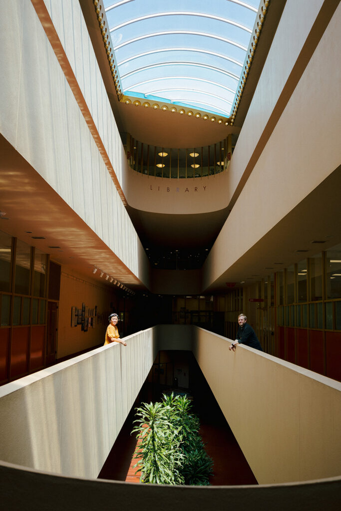 Bay Area engagement photos at Marin County Civic Center with a couple leaning across architectural railings.