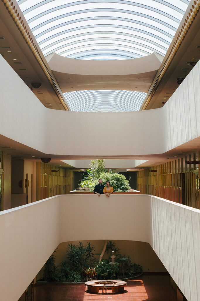 Bay Area engagement photos at Marin County Civic Center with a couple leaning against the architectural railing.