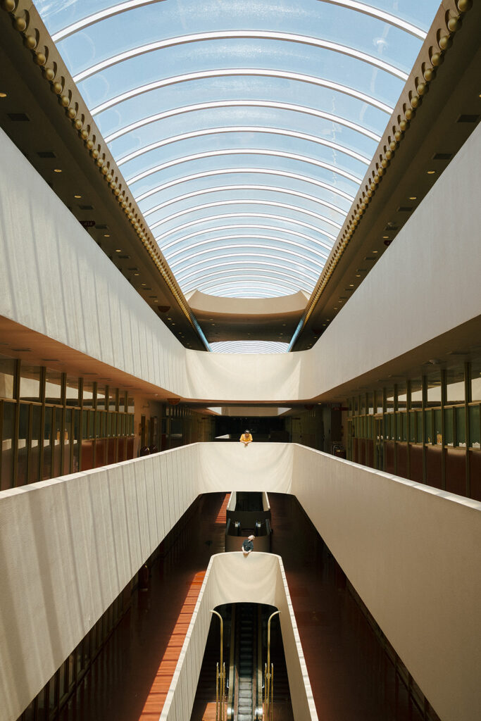 Creative Bay Area engagement photos at Marin County Civic Center with a couple framed by dramatic light and architecture.