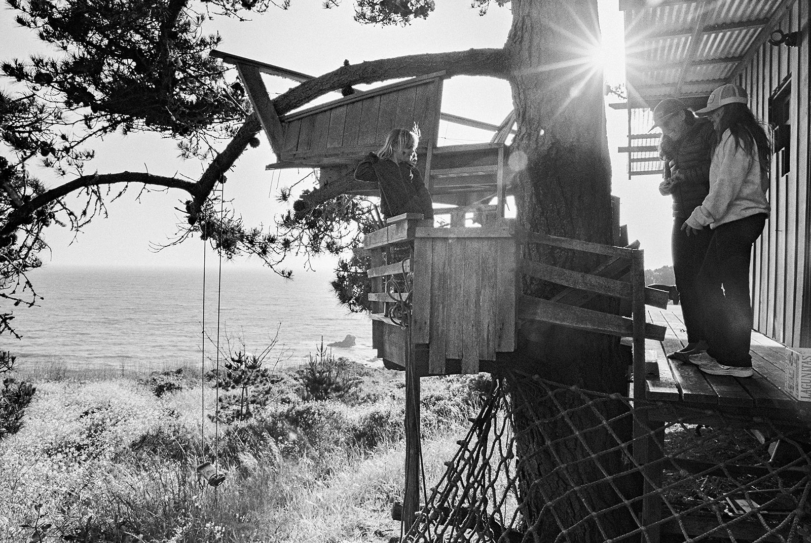 Black and white photo of people on a tree house structure at Slide Ranch.