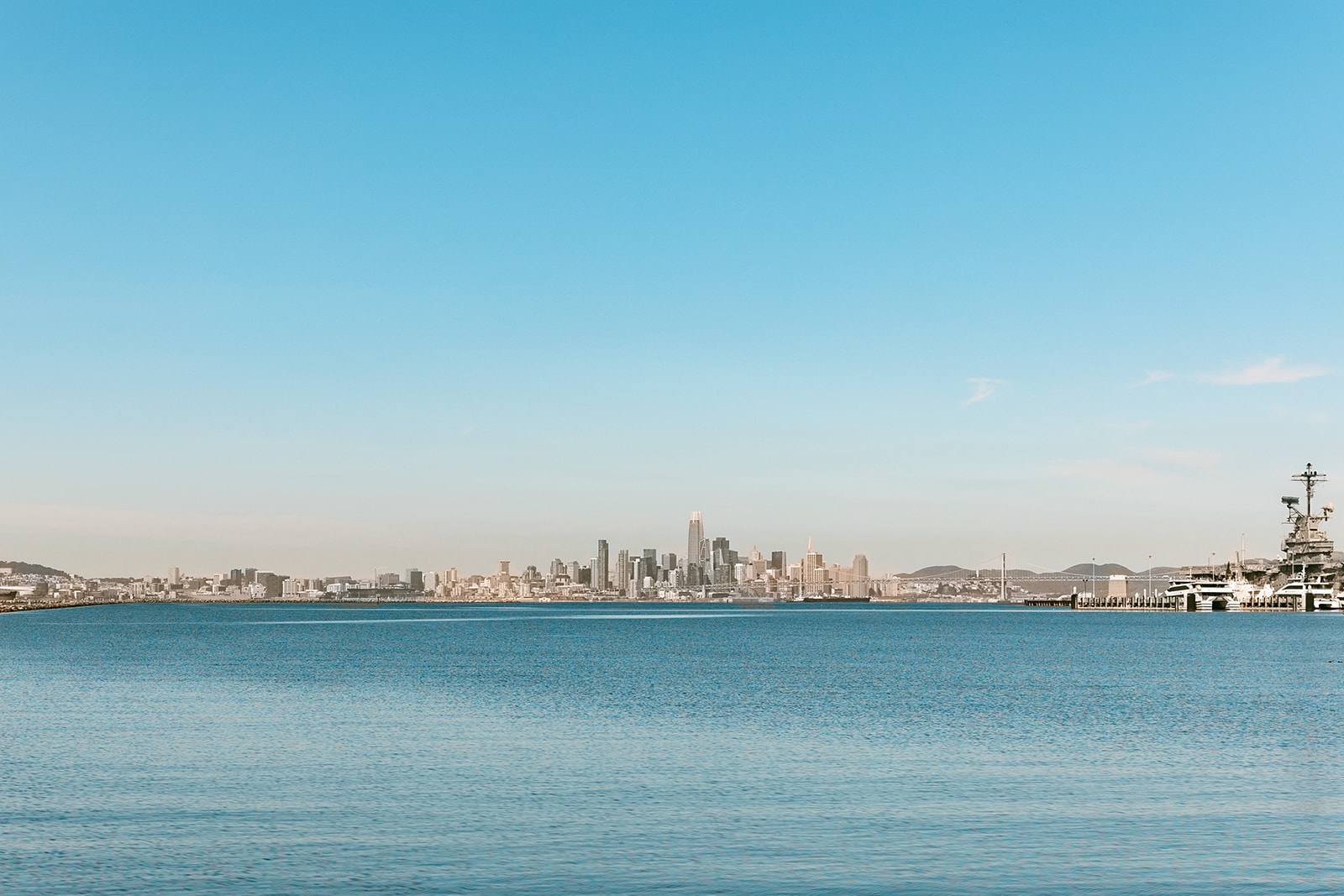 Wide view of the San Francisco skyline across the Bay from Alameda during a senior portrait session.