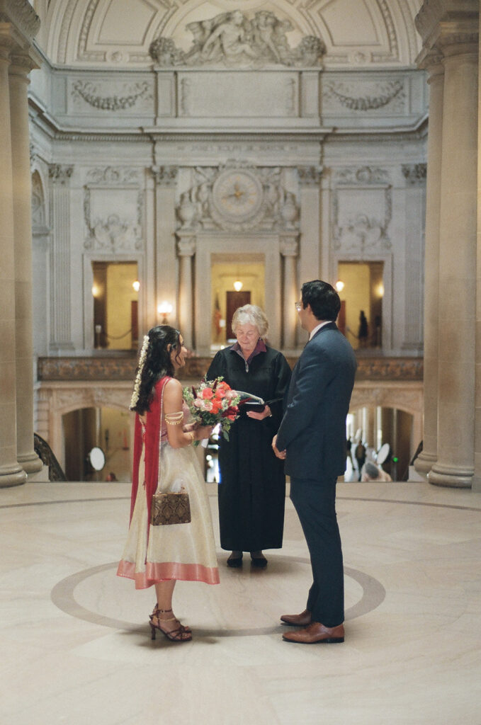 Couple during their San Francisco City Hall wedding ceremony on film.