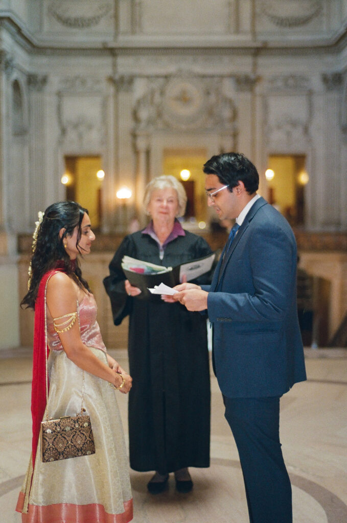 Groom reading his vows during an intimate San Francisco City Hall wedding ceremony.