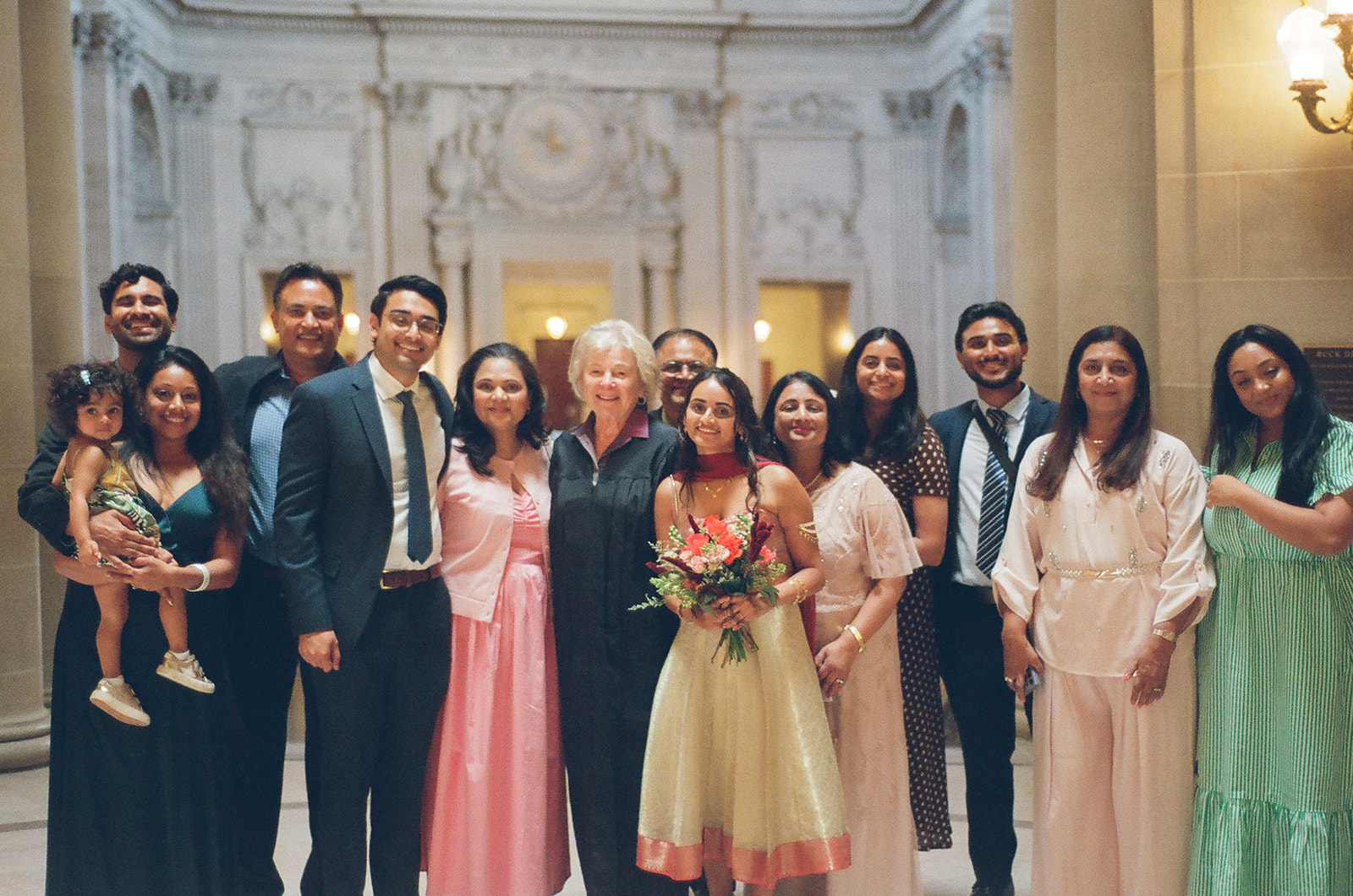 Bride and groom gathered with family and their officiant.