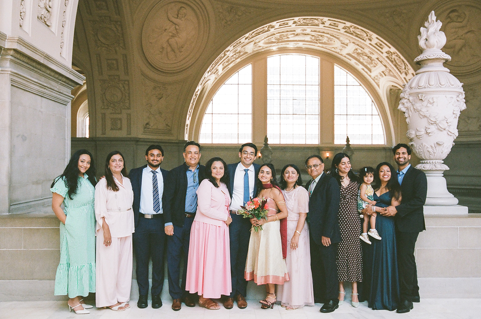 Group photo of the bride, groom, and their family after a civil ceremony.