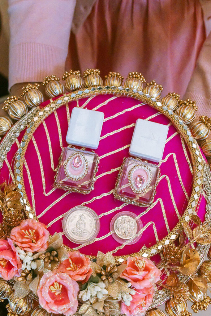 Colorful wedding detail tray with jewelry, flowers, and keepsakes.