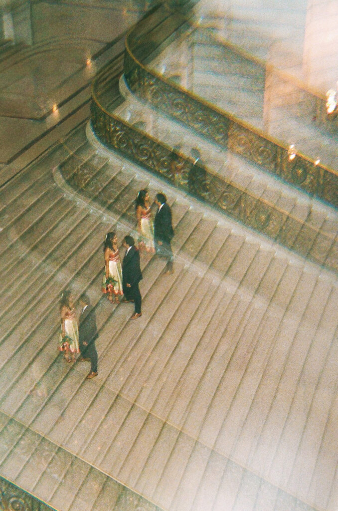 Creative double exposure of the newlyweds standing on the grand staircase at San Francisco City Hall.