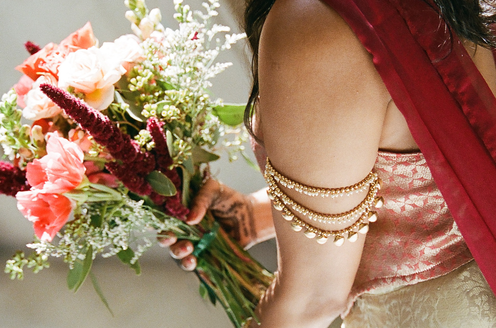 Bride holding her colorful wedding bouquet in the sunlight inside San Francisco City Hall.