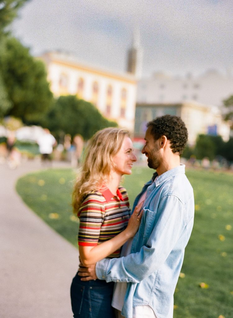 Candid photo of a couple together outside of Washington Square Park outside of Saints Peter and Paul Church.