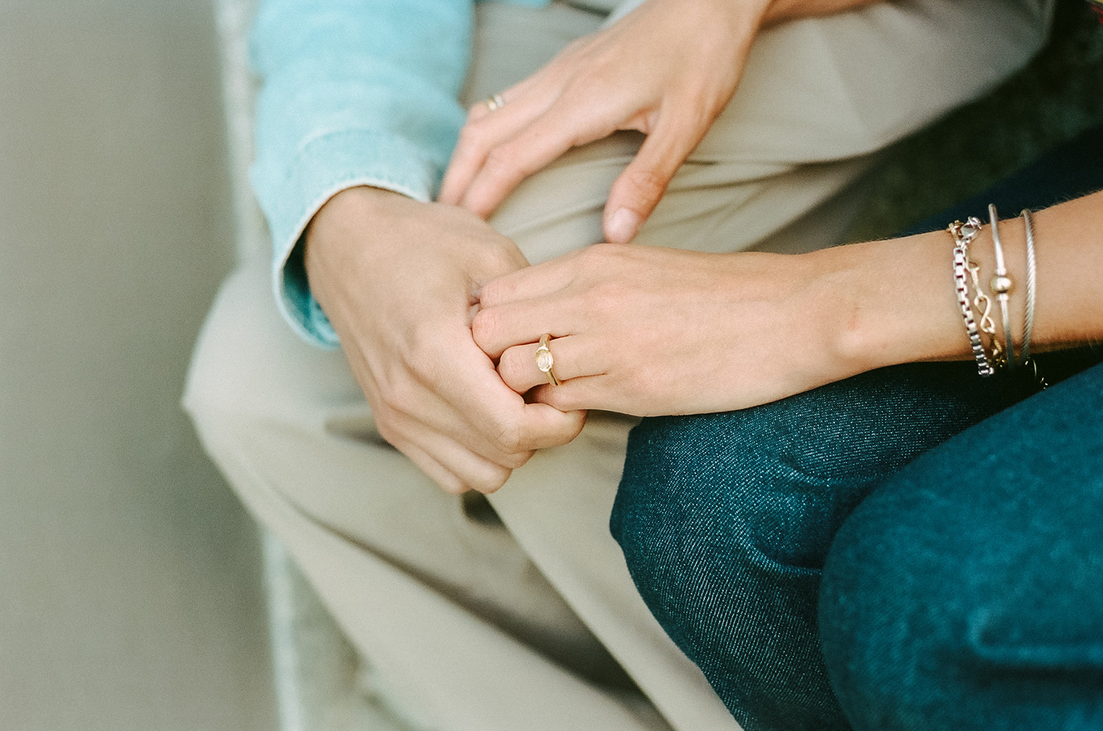 Close up photo of a couple holding hands together.