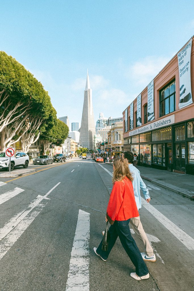 Candid photo of a couple walking across the street in North Beach,