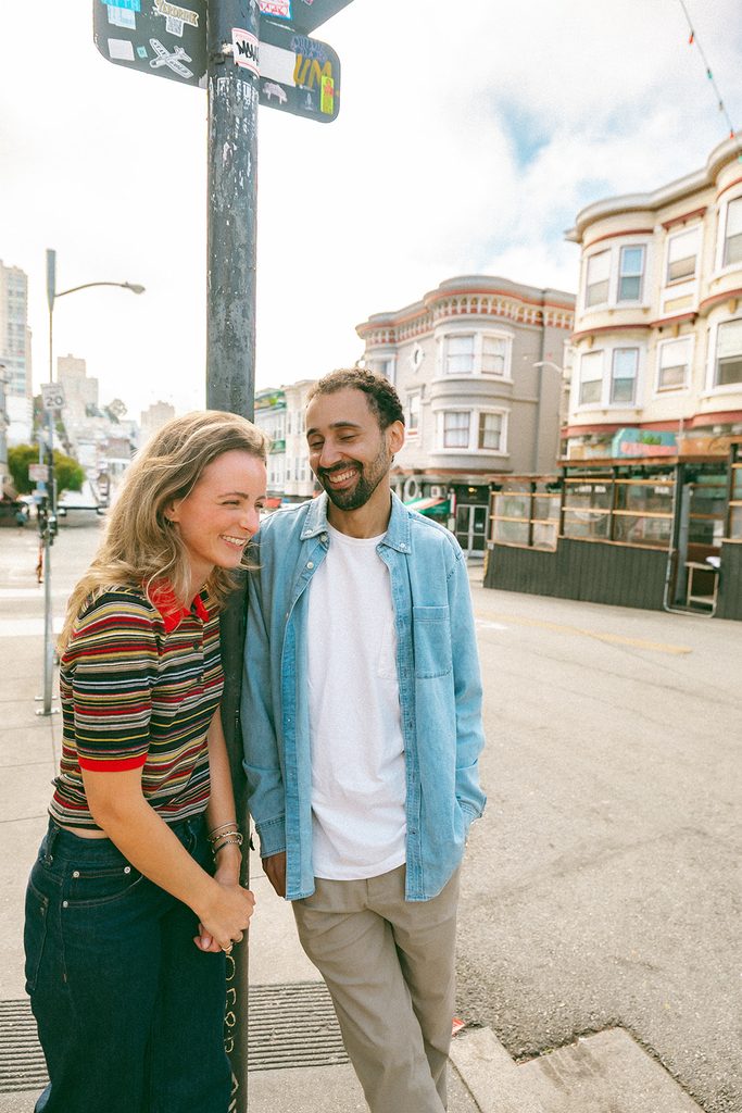 Candid photo of a couple laughing in North Beach for their SF engagement photos.