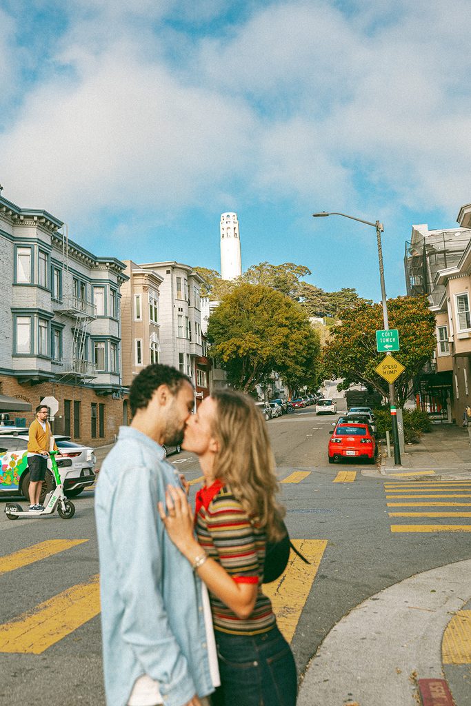 Couple kissing each other in North Beach for their SF engagement photos.